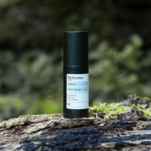 Load image into Gallery viewer, Product shot of ReGlow – Face Serum standing on a moss covered tree trunk
